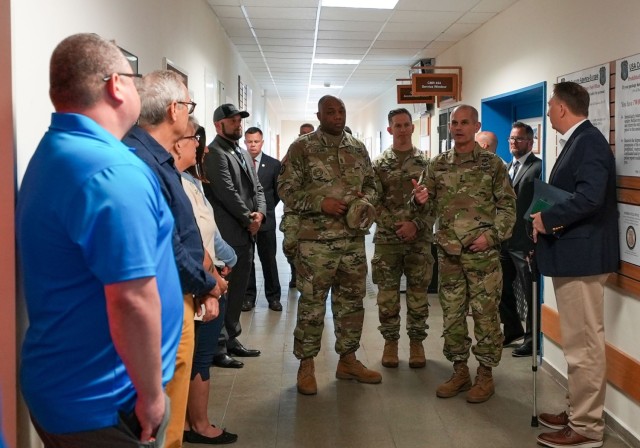 While visiting U.S. Army Garrison Ansbach Aug. 3, 2023, Lt. Gen. Omar J. Jones, IV and Command Sgt. Maj. Jason R. Copeland talk with teammates at the garrison headquarters, providing guidance, answering questions and thanking them for the job they do each day.