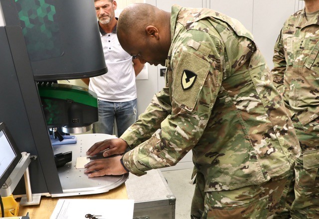 As part of the Installation Management command team visit to Clay Kaserne July 31 Lt. Gen. Omar J. Jones, IV and Command Sgt. Maj. Jason R. Copeland toured several U.S. Army Garrison Wiesbaden Directorate of Public Works machine shops. Copeland, with DPW supervision, was able to try his hand at laser engraving a name plate at the DPW key and engraving shop.
