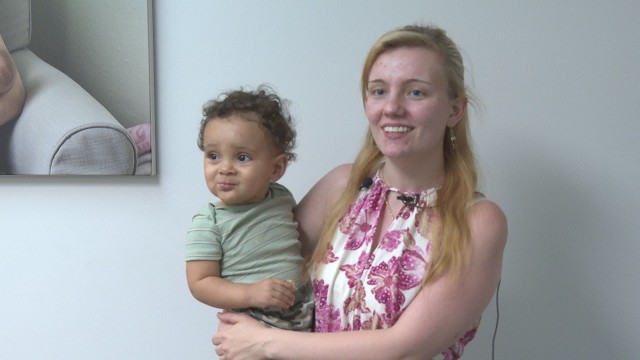 Grace Wolford, spouse of Spc. Devin Dennis, 1st Cav. Div., with son Azreal, shares how donating has help her through postpartum depression and helped support infants in need as well during the grand opening of the Fort Cavazos Milk Depot. (U.S. Army photo by Rodney Jackson, CRDAMC Public Affairs)