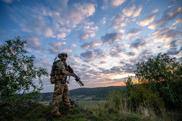 Soldiers stand watch at sunrise during Saber Junction 23