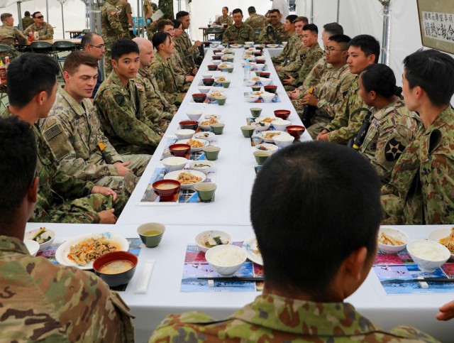 U.S. Army Soldiers and Japan Ground Self-Defense Force members share a meal together during Orient Shield 23. About 3,500 U.S. Soldiers and JGSDF members recently participated in the 10-day exercise to forge stronger bonds and increase interoperability.