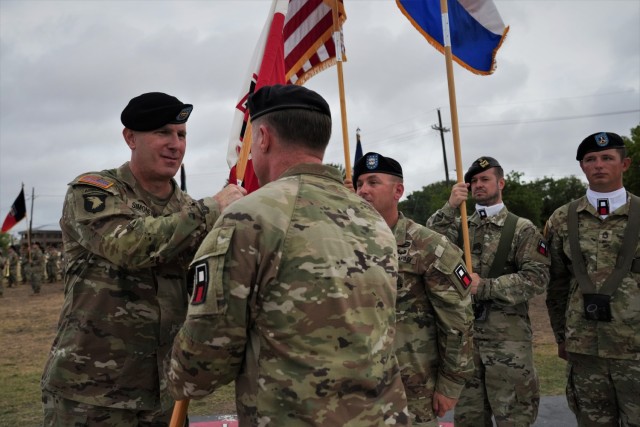 (From right) First Army Division West’s Commander Brig. Gen. William A. Ryan III passes the First Army Division West guidon to incoming Command Sgt. Maj. Vincent Simonetti during an Assumption of Responsibility Ceremony held at Fort Cavazos Sept. 21.