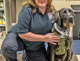 Photos of service dogs her gift to Veterans