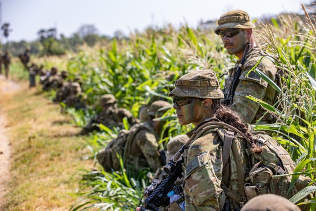 A group of Australian Defense Force (ADF) Soldiers, takes a knee while moving to the objective with their assigned weapon during a rehearsal for a Combat Live Fire Exercise during Exercise Super Garuda Shield 2023, at the 5th Marine Combat Training Center, Puslatpur, East Java, Indonesia., Sept. 9, 2023. Super Garuda Shield 2023 (SGS2023) is an annual exercise that has significantly grown in scope and size since 2009. SGS2023 is the second consecutive time this exercise has grown into a combined and joint event, highlighting the 7 participating and 12 observing nations' commitment to partnership and a free and open Indo-pacific. 