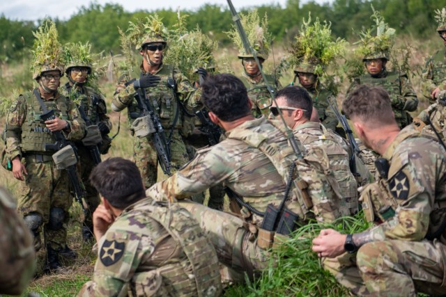 U.S. Army Soldiers from the 5-20th Infantry Regiment and Japan Ground Self-Defense Force Members discuss what lessons they learned during the bilateral  live-fire  exercise at Orient Shield 23, at Kamifurano Training Area, Japan, September 17,2023. Orient Shield 23 allows the U.S. Army and JGSDF to rehearse strategic movement and maneuver and demonstrate the unique contributions to the Joint Force. U.S. Army rotational forces to Japan help provide a capable, trained, and combat-ready force that will defend Japan. Orient Shield is the largest U.S. Army and Japan Ground Self-Defense Force bilateral field training exercise being executed in various locations throughout Japan to enhance interoperability, and test and refine multi-domain and cross-domain operations. 
