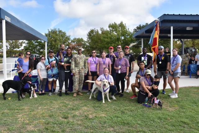 Col. Timothy Gatlin, 1st Cavalry Division Artillery Brigade, 1st Cavalry Division, commander, poses with the winners who placed the fastest walking and running times during the annual Domestic Violence Awareness Walk Oct. 4 at III Armored Corps Headquarters. (U.S. Army photo by Janecze Wright, Fort Cavazos Public Affairs)