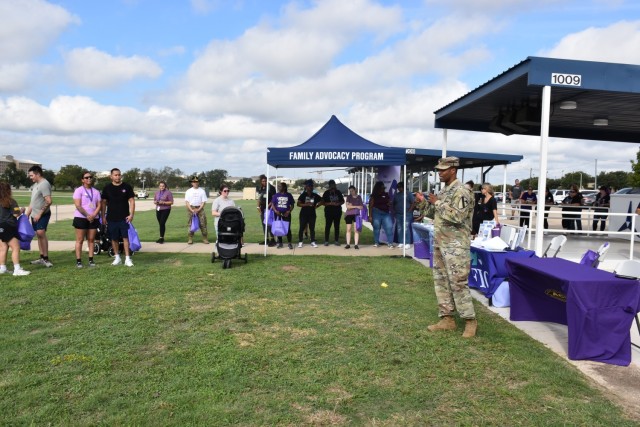 Col. Timothy Gatlin, 1st Cavalry Division Artillery Brigade, 1st Cavalry Division, commander, addresses attendees after the annual Domestic Violence Awareness Walk Oct. 4 at III Armored Corps Headquarters. Gatlin thanked the attendees for supporting the event and expressed gratitude to the Family Advocacy Program for their efforts. (U.S. Army photo by Janecze Wright, Fort Cavazos Public Affairs)