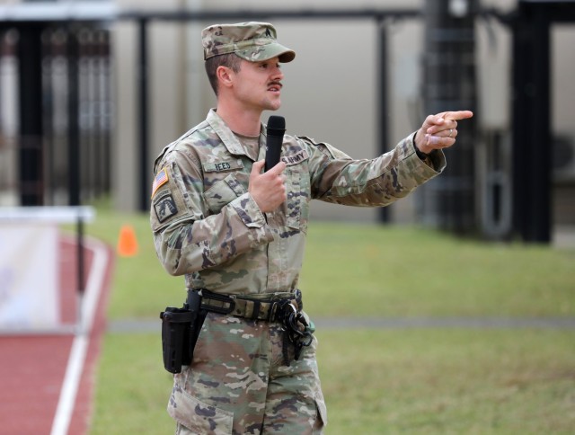 Sgt. Taylor Reed, a military working dog handler assigned to the 901st Military Working Dog Detachment, answers questions from Zama Middle High School students during a Red Ribbon Week event at Camp Zama, Japan, Oct. 31, 2023. The military working dog demonstration capped off the school's weeklong campaign that encouraged students to live a drug-free lifestyle.
