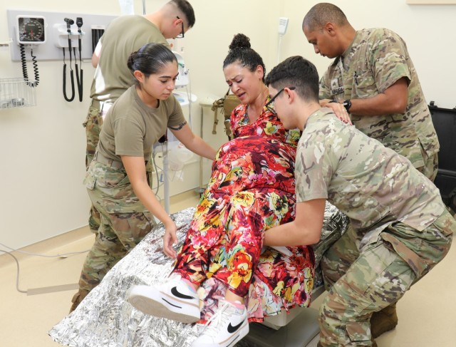 Medical personnel prepare to treat a volunteer who is portraying a pregnant patient with serious injuries during a mass casualty exercise inside the BG Sams U.S. Army Health Clinic at Camp Zama, Japan, Oct. 5, 2023.