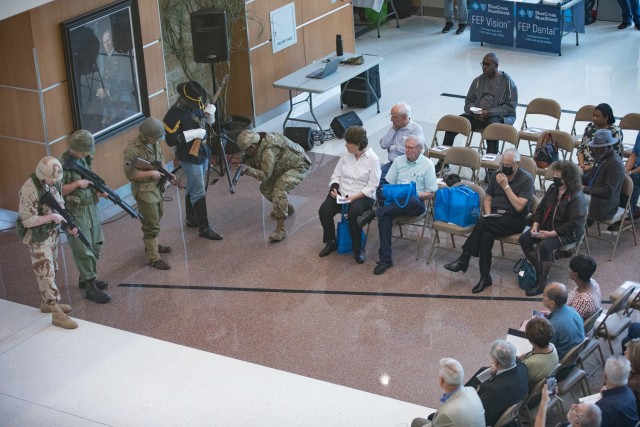 Current Soldiers conduct a special presentation with current and historical uniforms showcasing the history of the Army during the opening ceremony for Retiree Appreciation Day Oct. 28 at Carl R. Darnall Army Medical Center. (U.S. Army photo by Blair Dupre, Fort Cavazos Public Affairs)