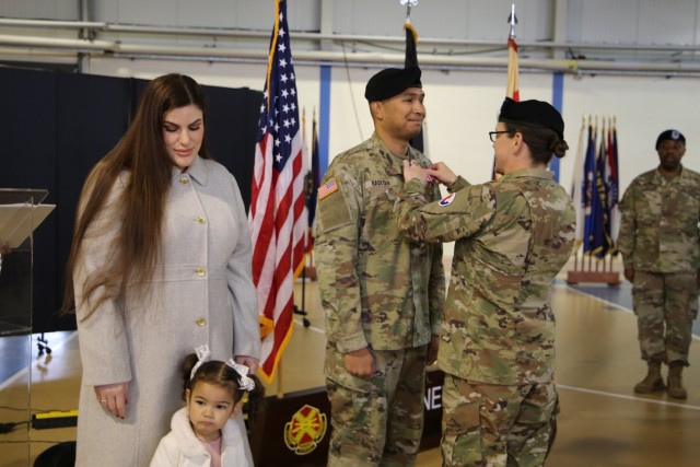 Col. Matthews pins Capt. Nabeyan during HHC's Change of Command Ceremony