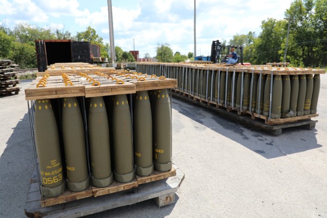 Ammo handler at Blue Grass Army Depot prepares 155mm projectile rounds for repalletization.