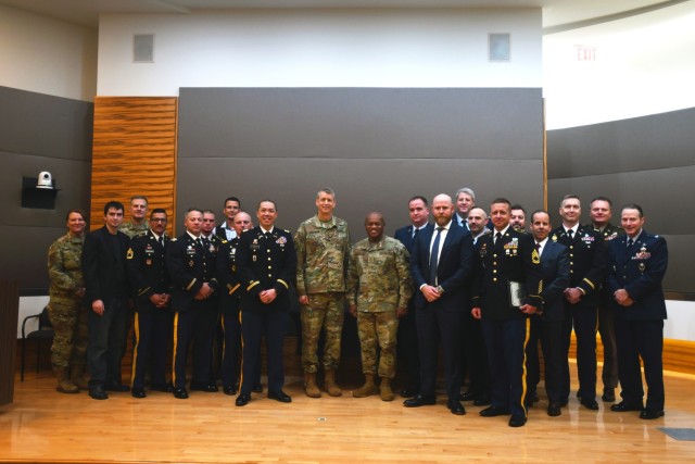 Army Gen. Daniel Hokanson, chief of the National Guard Bureau, and Senior Enlisted Advisor Tony Whitehead, SEA to the CNGB, center left and center right, respectively, with competitors of the 2023 National Guard Bureau Innovation Challenge at the Herbert R. Temple Jr. Army National Guard Readiness Center, Arlington Hall Station, Virginia, Dec. 7, 2023. Arizona Army National Guard members took home top honors for their concept of exportable maneuver live-fire capabilities that could help units achieve training requirements. (U.S. Air National Guard photo by Master Sgt. Erich B. Smith)