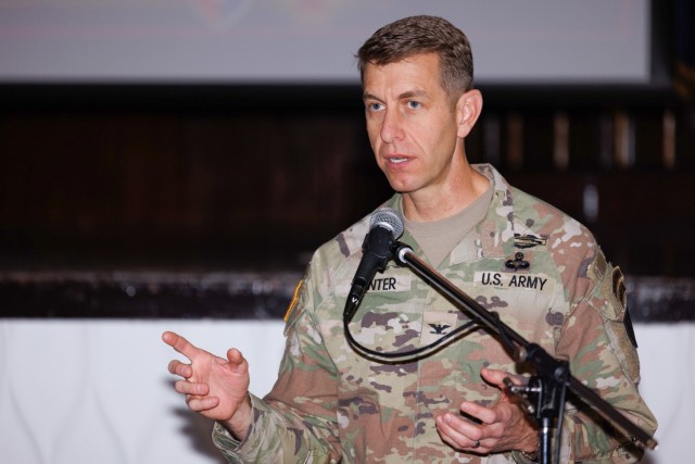 Col. Marcus Hunter, commander of U.S. Army Garrison Japan, provides remarks during a workforce town hall inside Kizuna Hall at Camp Zama, Japan, Dec. 6, 2023. In the meeting, leaders discussed plans for a new workforce action team and other topics. 