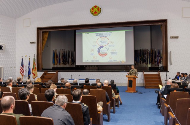 Col. Marcus Hunter, commander of U.S. Army Garrison Japan, provides remarks during a workforce town hall inside Kizuna Hall at Camp Zama, Japan, Dec. 6, 2023. In the meeting, leaders discussed plans for a new workforce action team and other topics. 