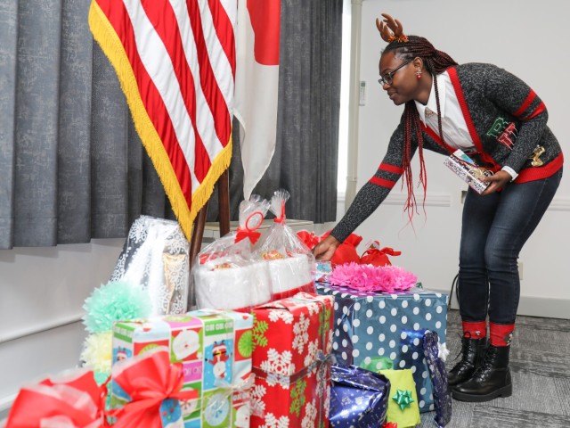 Kristen Bennett, who works at Logistics Readiness Center-Honshu, collects gifts to be delivered to a local children's home in Zama, Japan, Dec. 22, 2023. LRC-Honshu employees donated the gifts to nearly 50 children at the home. 