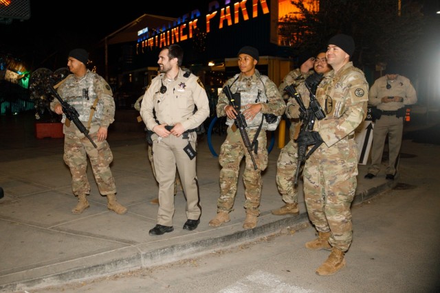 Soldiers from the 1st Squadron, 221st Cavalry works with local law enforcement in downtown Las Vegas, Nevada, Dec. 31, 2023. The soldiers worked closely with local law enforcement to bolster security during the New Year's Eve celebrations. 