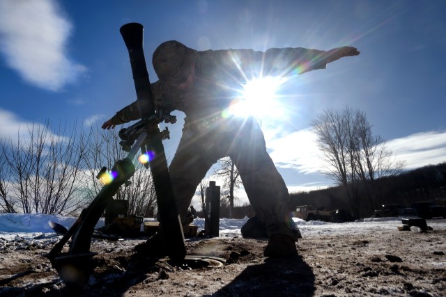 Spc. Emilio Bailey, an indirect fire infantryman with Headquarters and Headquarters Company, 1st Battalion, 125th Infantry Regiment, Michigan Army National Guard, signals to others in his unit while sighting in an 81 mm mortar during exercise Northern Strike 24-1 at Camp Grayling Maneuver Training Center, Michigan, Jan. 21, 2024. Northern Strike 24-1 is the winter warfare component of the annual National Guard Bureau-sponsored Northern Strike exercise series. (U.S. Army photo by Sgt. 1st Class Jon Soucy)