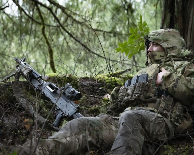 Washington National Guard Soldiers with Bravo Company, 3rd Battalion, 161st Infantry Regiment, 81st Stryker Brigade Combat Team, react to contact during squad training, on Joint Base Lewis-McChord, Jan. 6, 2024. By practicing excellence in the basics, Infantrymen are ready for any mission, local or abroad. 