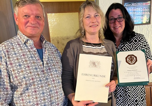 Dani Danhauser, a supply clerk assigned to Base Support Operations Maintenance, 405th Army Field Support Brigade (center), was honored recently with a Years of Service Certificate for her 40 years as 