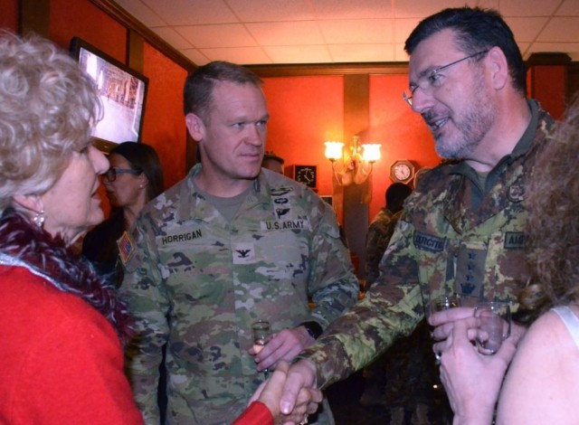 From left to right: Francesca Gheller-Dorrity, a local survivor spouse and mother, Col. Scott Horrigan, USAG-Italy Commander, and Italian base commander Col. Michele Amendolagine, attend the annual survivor's holiday party.  