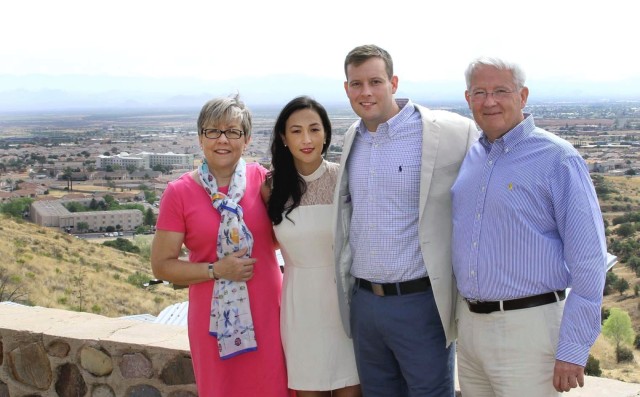 Katie Collins, Maj. Liz Collins, Maj. Andrew Collins, and John Collins pose for a photo after Liz and Andrew exchanged wedding vows at the top of Reservoir Hill at Fort Huachuca in Arizona. Katie and John are Andrew's parents.
