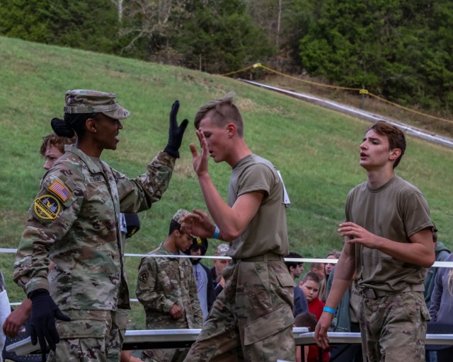 Brig. Gen. Amanda Azubuike, Army Cadet Command deputy commanding general high fives JROTC Cadets as they finish the 5K run at Fort Knox on Nov. 4, 2023 during the Junior ROTC National Raider Challenge. The JROTC National Raider Challenge is an annual championship event for JROTC Raider Challenge teams which was hosted by Cadet Command for the first time at Fort Knox, Kentucky. From Nov. 2-5, more than 3,000 Army junior ROTC cadets from more than 180 high schools competed to be the best Raider team in the nation. | Photo by Savannah Baird, U.S. Army Public Affairs Office