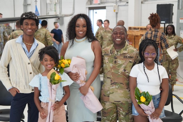 Sgt. 1st Class Lacy Harrell Jr. poses for a photo with his family following his change of responsibility ceremony to become a first sergeant with Alpha Company, 15th Military Intelligence Battalion at Fort Cavazos, Texas. This was the first military ceremony his family was able to attend in his 18-year career. 