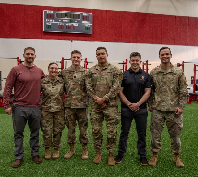 Part of the 1st Infantry Division 2nd Armored Bridage Combat Team Holistic Health and Fitness team, U.S. Army Soldiers and DOD Civilians, gather for a photo on Fort Riley, Kansas, Feb. 13, 2024. The H2F team spreads knowledge, information and resources to Soldiers to help them maintain healthy lifestyles. (U.S. Army photo by Pfc. Autumn Johnson)