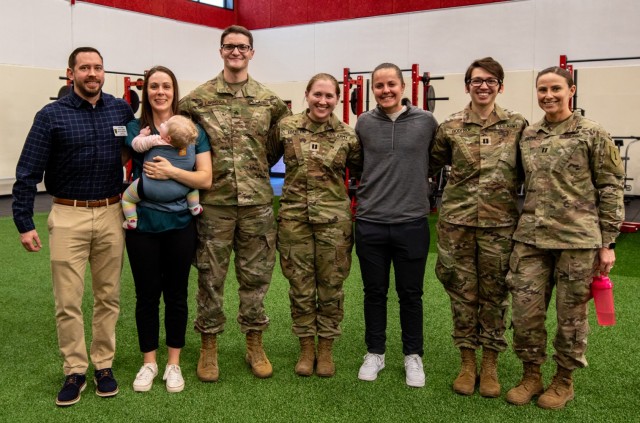 U.S. Army Soldiers assigned to 1st Armored Brigade Combat Team Holistic Health and Fitness Team, 1st Infantry Division , alongside DOD Civilians from the 1st ABCT H2F team, gather for a photo at Long Fitness Center on Fort Riley, Kansas, Feb. 13, 2024. The H2F team spreads knowledge, information, and resources to Soldiers to help them maintain healthy lifestyles. (U.S. Army photo by Pfc. Autumn Johnson)