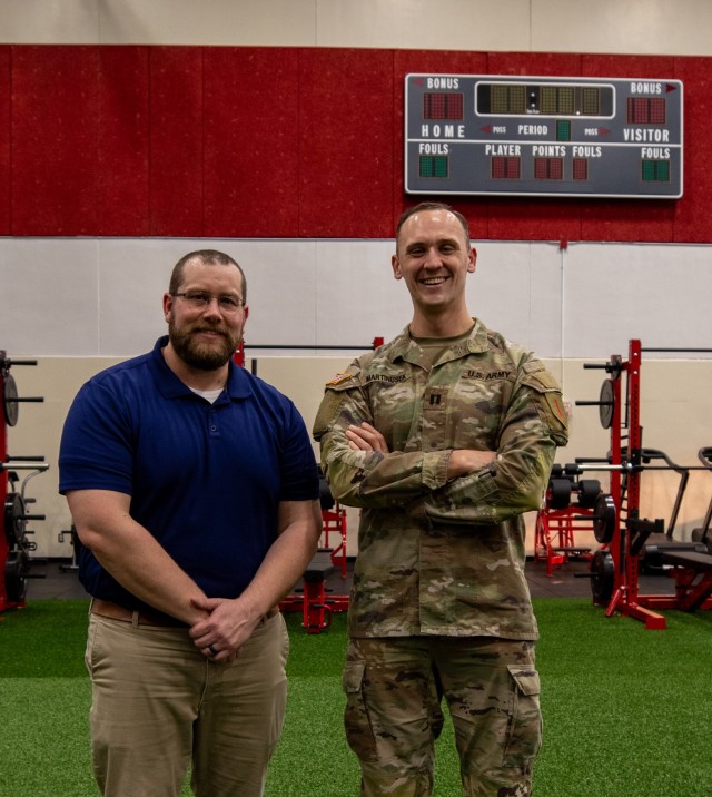 U.S. Army Capt. Robert Martinusek, the unit control officer assigned to 1st Infantry Division Sustainment Brigade Holistic Health and Fitness Team, 1st Infantry Division alongside DOD Civilian Justin Anderson, 1st Inf. Div. Sust. Bde. H2F,  stand for a photo at Long Fitness Center on Fort Riley, Kansas, Feb. 13, 2024. The H2F team spreads knowledge, information and resources to Soldiers to help them maintain healthy lifestyles. (U.S. Army photo by Pfc. Autumn Johnson)