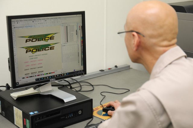 Takashi Yamamoto, an electronic mechanic with Logistics Readiness Center-Honshu, designs a decal for a new military police vehicle at Sagami General Depot, Japan, Feb. 7, 2024. U.S. Army Garrison Japan worked with partners to receive 12 patrol vehicles following a lengthy procurement process.