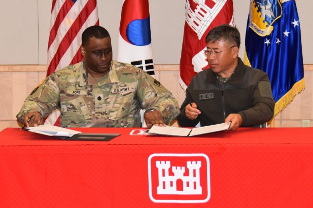Lt. Col. Yun, Jeong Hyun, RoK Design and Construction Agent (DCA), officially transfers the final project of the Yongsan Relocation Project in the Pyeongtaek area to Lt. Col. Michael Pope, US DCA, in a ceremony on Nov. 30 at Osan Air Base. After over 16 years of construction, it marks the conclusion of the construction phase of the relocation of US troops to USAG Humphreys from Yongsan Garrison in Seoul. 
