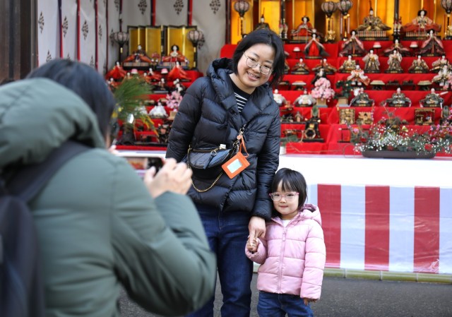 Chenjia Yin, center, and her daughter, Erin Li, pose for a photo in front of a doll display in celebration of the Dolls Festival, or "Hinamatsuri," at the Zama Shrine in Japan, March 1, 2024. The Army Community Service at Camp Zama hosted a walking tour to the shrine for community members to enjoy the festival. 