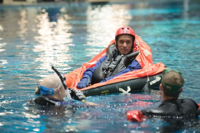 During water survival training in 2017 at NASA Johnson Space Center’s Neutral Buoyancy Laboratory in Houston, NASA astronaut candidate Frank Rubio is guided through training by divers.