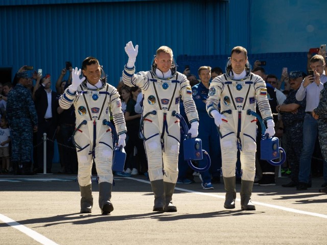 Expedition 68 astronaut Frank Rubio of NASA, left, and cosmonauts Sergey Prokopyev and Dmitri Petelin of Roscosmos, wave farewell as they depart building 254 for the launch pad and their Soyuz MS-22 spacecraft launch, Wednesday, Sept. 21, 2022, in Baikonur, Kazakhstan. Rubio, Prokopyev and Petelin launched onboard the Soyuz rocket from the Baikonur Cosmodrome for a mission on the International Space Station.