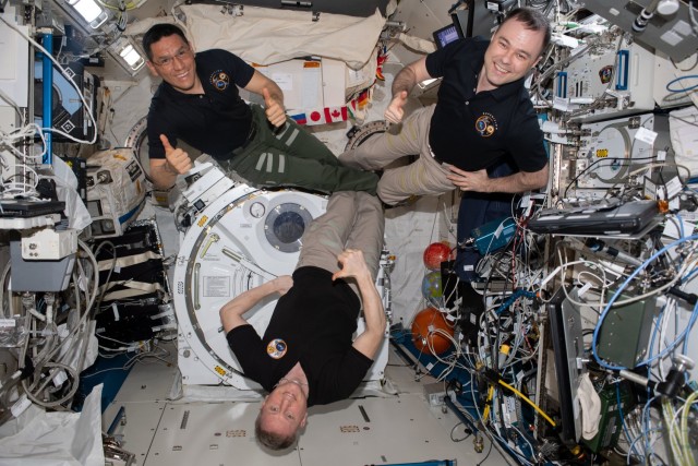 Three International Space Station crew members who joined the Expedition 67 crew on Sept. 21, 2022, and are now Expedition 69 crew members nearly a year later, pose for a portrait inside the Kibo laboratory module. Clockwise from top left are, Flight Engineers Frank Rubio of NASA and Dmitri Petelin of Roscosmos and Commander Sergey Prokopyev of Roscosmos.