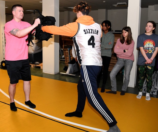 Staff Sgt. Nicholas Klein teaches a student defensive techniques during a self-defense class.