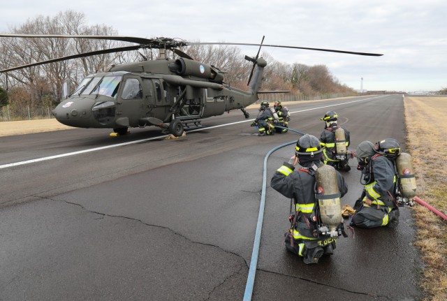 U.S. Army Garrison Japan firefighters extinguish a mock fire on a UH-60 Black Hawk helicopter as part of a downed aircraft exercise at Camp Zama, Japan, March 7, 2024. Firefighters also evacuated the aircrew to a nearby safe location and used radio communication to coordinate their efforts with the air traffic control tower.
