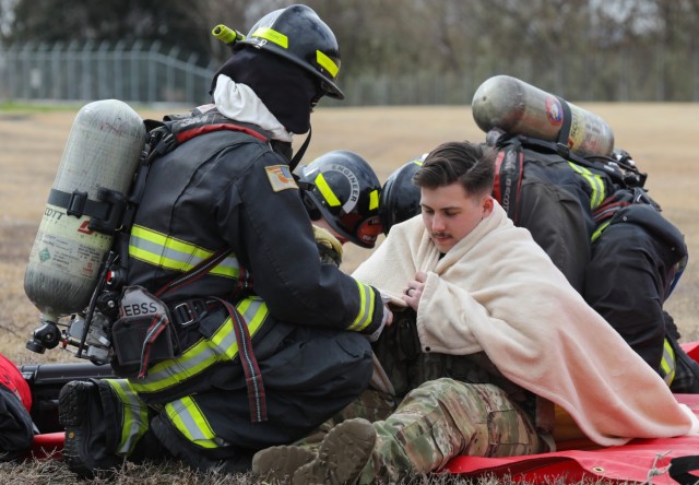 U.S. Army Garrison Japan firefighters treat an aircrew member during a downed aircraft exercise at Camp Zama, Japan, March 7, 2024. The firefighters arrived at the scene within two minutes while using radio communication to coordinate their efforts with the air traffic control tower.