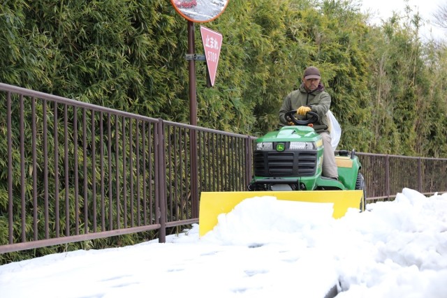 A base employee clears snow from sidewalks on Camp Zama on Feb. 6, 2024, after heavy snow and slush covered the Kanto Plain. The community remained prepared for the event thanks to the hard work of a joint weather council.