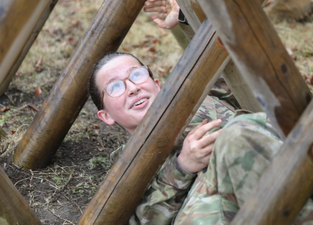 Cadet Cheyenne Coleman navigates an obstacle at Camp Zama, Japan, March 12, 2024. Soldiers from the 35th Combat Sustainment Support Battalion hosted a field day to familiarize Zama Middle High School cadets with some aspects of Army life, including a confidence course and the Army Combat Fitness Test. 