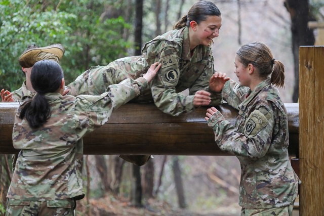 Cadets Liliana Fennessey, center, Chelsea Sanchez, left, and Hailey Momerak work together to tackle an obstacle while completing a confidence course at Camp Zama, Japan, March 12, 2024. Soldiers from the 35th Combat Sustainment Support Battalion hosted a field day to familiarize Zama Middle High School cadets with some aspects of Army life.