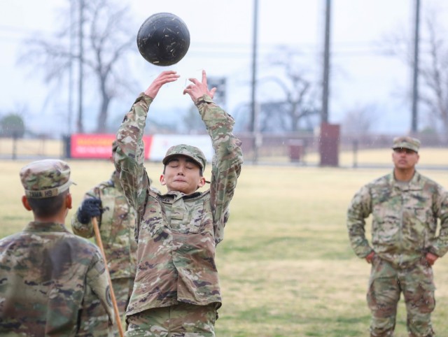 Cadet Noah Hogan performs the standing power throw event as he takes the Army Combat Fitness Test at Camp Zama, Japan, March 12, 2024. Soldiers from the 35th Combat Sustainment Support Battalion hosted a field day to familiarize Zama Middle High School cadets with some aspects of Army life.