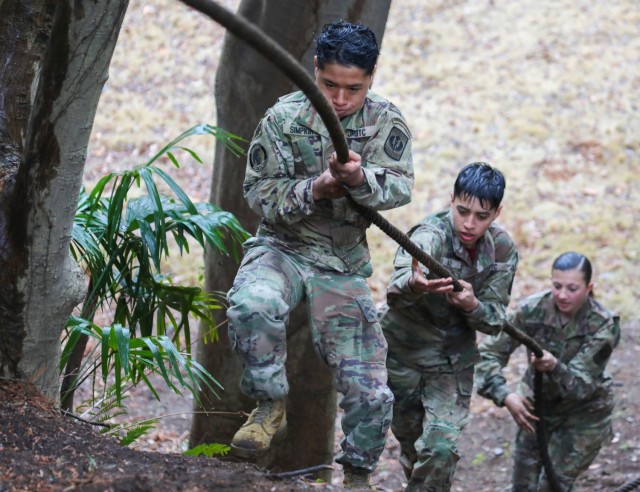 Cadets Gabriel Simpkins, left, Thomas Diaz and Liliana Fennessey work together to complete a confidence course at Camp Zama, Japan, March 12, 2024. Soldiers from the 35th Combat Sustainment Support Battalion hosted a field day to familiarize Zama Middle High School cadets with some aspects of Army life. 