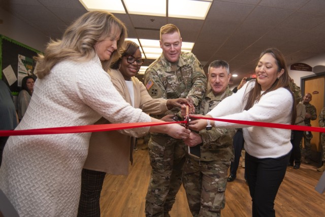 At a Jan. 30 event in Bldg. 470 to open Fort Leonard Wood’s new Spouse Resource Center, the ceremonial ribbon is cut by (from left) military spouse and volunteer Sally Beck; Eyonda Williams, with the Directorate of Human Resources; Maj. Gen. Christopher Beck, Maneuver Support Center of Excellence and Fort Leonard Wood commanding general; Col. Anthony Pollio, U.S. Army Garrison Fort Leonard Wood commander; and Vanessa Arzabala, a military spouse and Truman Army Education and Personnel Testing Center guidance counselor, who will help operate the SRC. The center, located in Room 2222, is designed to provide military spouses with community, education and employment resources, on and off the installation, and will host weekly workshop events.