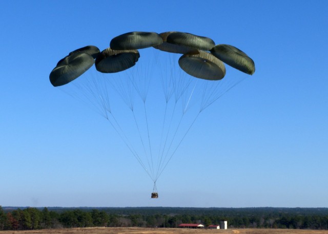 Airborne troops drop test new Family of Medium Tactical Vehicles at Ft. Liberty