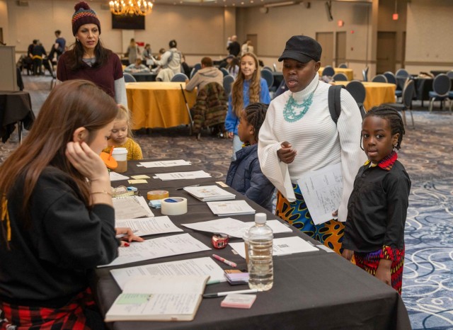 Community members speak to a talent and model agency during a modeling fair at the Camp Zama Community Club in Japan, March 2, 2024. About 200 people attended the event, which also kicked off this year's Army Emergency Relief campaign.