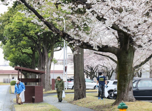 Camp Zama community members and Japan Ground Self-Defense Force partners pick up trash along 4th Avenue as part of a cleanup event at Camp Zama, Japan, April 3, 2024.