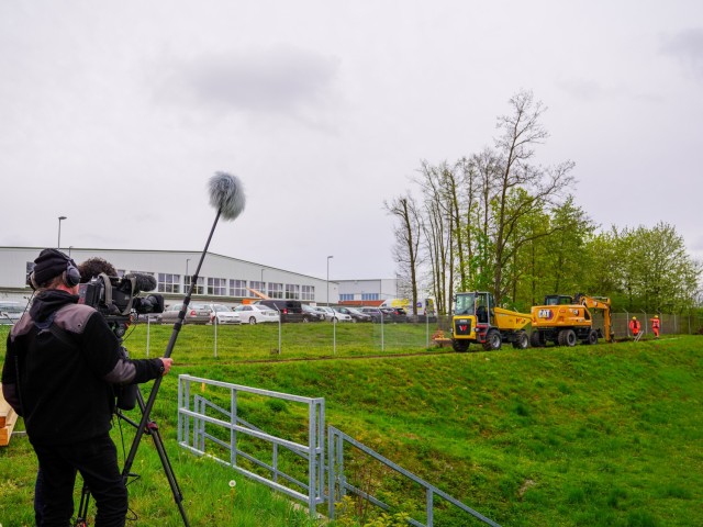ANSBACH, Germany (April 10, 2024) - While a media crew looks on, a construction team digs the first pipe trenches for U.S. Army Garrison Ansbach's (USAG) Pump and Treat facility on Katterbach Kaserne. The facility is the main part of the garrison's per- and polyfluorinated chemicals (PFAS) remediation efforts which will include not only the 21 measuring points within the U.S. Army footprint, but also measuring points within the city of Ansbach and the surrounding area. USAG Ansbach is a U.S. Army Power Projection Platform consisting of aviation, engineering, and artillery assets spread across nine kasernes in the heart of Middle Franconia, Germany. (U.S. Army photo by Jonathan Bell/Released)